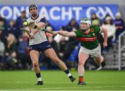 6 January 2024; Martin Cullen of New York has his shot blocked by Luke Connor of Mayo during the Connacht Hurling League Cup final match between New York and Mayo at University of Galway Connacht GAA AirDome in Bekan, Mayo. Photo by Tyler Miller/Sportsfile