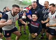 6 January 2024; Daithi Hartnett, aged 7, son of New York manager Richie Hartnett celebrates with the cup after the Connacht Hurling League Cup final match between New York and Mayo at University of Galway Connacht GAA AirDome in Bekan, Mayo. Photo by Tyler Miller/Sportsfile