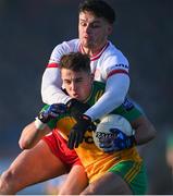 7 January 2024; Peadar Mogan of Donegal is tackled by Michael McKernan of Tyrone during the Bank of Ireland Dr McKenna Cup Group A match between Tyrone and Donegal at O’Neills Healy Park in Omagh, Tyrone. Photo by Ramsey Cardy/Sportsfile