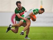 7 January 2024; Eoin Walsh of London is tackled by Conor Hunt of Mayo during the Connacht FBD League quarter-final match between Mayo and London at University of Galway Connacht GAA AirDome in Bekan, Mayo. Photo by Tyler Miller/Sportsfile