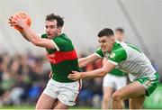 7 January 2024; Conor Hunt of Mayo in action against DJ O'Flaherty of London during the Connacht FBD League quarter-final match between Mayo and London at University of Galway Connacht GAA AirDome in Bekan, Mayo. Photo by Tyler Miller/Sportsfile