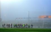 7 January 2024; Kilmacud Crokes players stand amongst the fog for the national anthem before the AIB GAA Football All-Ireland Senior Club Championship semi-final match between Kilmacud Crokes of Dublin, and Glen of Derry, at Páirc Esler in Newry, Down. Photo by Ben McShane/Sportsfile