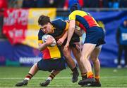 9 January 2024; Roger Doyle of The King's Hospital is tackled by Harry Connolly of St Fintan's, left, and Marcel Haas during the Bank of Ireland Vinnie Murray Cup Round 1 match between The Kings Hospital and St Fintan's High School at Energia Park in Dublin. Photo by Tyler Miller/Sportsfile