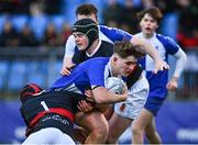 9 January 2024; Max Kickham of St Andrews College is tackled by Jamie Morton Bailey of The High School, 1, and Finn McLean during the Bank of Ireland Vinnie Murray Cup Round 1 match between The High School and St Andrews College at Energia Park in Dublin. Photo by Tyler Miller/Sportsfile