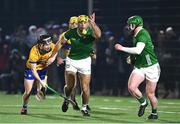 10 January 2024; Dan Morrissey of Limerick passes under pressure from Diarmuid Cahill of Clare during the Co-Op Superstores Munster Hurling League Group A match between Clare and Limerick at Clarecastle GAA astro pitch in Clare. Photo by Piaras Ó Mídheach/Sportsfile