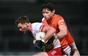 10 January 2024; Michael McKernan of Tyrone is tackled by Ciaran Higgins of Armagh during the Bank of Ireland Dr McKenna Cup Group A match between Armagh and Tyrone at BOX-IT Athletic Grounds in Armagh. Photo by Ben McShane/Sportsfile