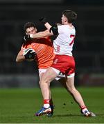 10 January 2024; Niall Grimley of Armagh is tackled by Niall Devlin of Tyrone during the Bank of Ireland Dr McKenna Cup Group A match between Armagh and Tyrone at BOX-IT Athletic Grounds in Armagh. Photo by Ben McShane/Sportsfile