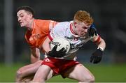 10 January 2024; James Garrity of Tyrone gets away from Connaire Mackin of Armagh during the Bank of Ireland Dr McKenna Cup Group A match between Armagh and Tyrone at BOX-IT Athletic Grounds in Armagh. Photo by Ben McShane/Sportsfile