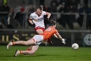 10 January 2024; Lorcan McGarrity of Tyrone has a shot on goal despite the attention of Jarly óg Burns of Armagh during the Bank of Ireland Dr McKenna Cup Group A match between Armagh and Tyrone at BOX-IT Athletic Grounds in Armagh. Photo by Ben McShane/Sportsfile