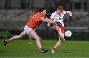 10 January 2024; James Garrity of Tyrone in action against Ciaran Higgins of Armagh during the Bank of Ireland Dr McKenna Cup Group A match between Armagh and Tyrone at BOX-IT Athletic Grounds in Armagh. Photo by Ben McShane/Sportsfile
