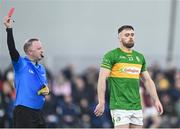 6 January 2024; Conor Reynolds of Leitrim is shows the red card, for a second yellow card offence, by referee Paul Lydon during the Dioralyte O'Byrne Cup quarter-final match between Offaly and Dublin at Gracefield GAA club in Kilmalogue, Offaly Photo by Piaras Ó Mídheach/Sportsfile