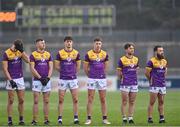 13 January 2024; Wexford players, from left, Liam Coleman, Tom Byrne, Cathal Walsh, Gavin Sheehan, Ben Brosnan and Conor Carty stand for the playing of the National Anthem before the O'Byrne Cup semi-final match between Dublin and Wexford at Parnell Park in Dublin. Photo by Stephen Marken/Sportsfile