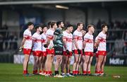 13 January 2024; Derry players stand for Amhrán na bhFiann before the Bank of Ireland Dr McKenna Cup semi-final match between Armagh and Derry at BOX-IT Athletic Grounds in Armagh. Photo by Ben McShane/Sportsfile