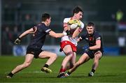 13 January 2024; Paul Cassidy of Derry in action against Tomás McCormack, left, and Darragh McMullan of Armagh during the Bank of Ireland Dr McKenna Cup semi-final match between Armagh and Derry at BOX-IT Athletic Grounds in Armagh. Photo by Ben McShane/Sportsfile
