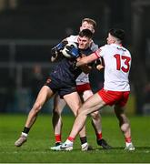13 January 2024; Darragh McMullan of Armagh is tackled by Declan Cassidy, behind, and Ben McCarron of Derry during the Bank of Ireland Dr McKenna Cup semi-final match between Armagh and Derry at BOX-IT Athletic Grounds in Armagh. Photo by Ben McShane/Sportsfile