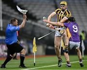 13 January 2024; Marty Murphy of Tullogher Rosbercon in action against Shane Cotter of St Catherine's as linesman Tarlach Conway calls for a line ball during the AIB GAA Hurling All-Ireland Junior Club Championship final match between St Catherine's of Cork and Tullogher Rosbercon of Kilkenny at Croke Park in Dublin. Photo by Piaras Ó Mídheach/Sportsfile