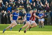 14 January 2024; Gavin Lee of Galway gets away from Laois players Aaron Dunphy, left, and Tom Cuddy during the Dioralyte Walsh Cup Round 3 match between Galway and Laois at Duggan Park in Ballinasloe, Galway. Photo by Seb Daly/Sportsfile