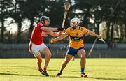 14 January 2024; Aidan McCarthy of Clare in action against Ger Millerick of Cork during the Co-Op Superstores Munster Hurling League Group A match between Cork and Clare at Páirc Uí Rinn in Cork.  Photo by Eóin Noonan/Sportsfile