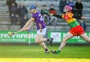 14 January 2024; Jack Doran of Wexford shoots to score his side's third goal despite the efforts of Dion Wall of Carlow during the Dioralyte Walsh Cup Round 3 match between Wexford and Carlow at Chadwicks Wexford Park in Wexford. Photo by Tyler Miller/Sportsfile