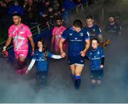 13 January 2024; Match day mascots Lauren Barrett, aged eight, left, and Mabel Keating, aged seven, walk out of the tunnel with Leinster co-captain Garry Ringrose before the Investec Champions Cup Pool 4 Round 3 match between Leinster and Stade Francais at the Aviva Stadium in Dublin. Photo by Sam Barnes/Sportsfile