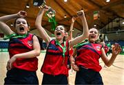 16 January 2024; Coláiste Na Carraige players, from left, Saoirse O'Donnell, Laura Boyle, and Laoise McGinley of Coláiste Na Carraige celebrate with the cup after their side's victory in the Pinergy Basketball Ireland U16B Girls Schools Cup Final match between Coláiste Na Carraige, Donegal and St Andrew's College, Dublin, at National Basketball Arena in Tallaght, Dublin. Photo by Tyler Miller/Sportsfile