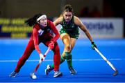 16 January 2024; Hyobi Kim of Korea Republic in action against Sarah Torrans of Ireland during the FIH Women's Olympic Hockey Qualifying Tournament Pool A match between Ireland and Korea Republic at Campo de Hockey Hierba Tarongers in Valencia, Spain. Photo by Manuel Queimadelos/Sportsfile