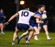 16 January 2024; David Garland of UCD is tackled by Ben McCarron of Ulster University during the Electric Ireland Higher Education GAA Sigerson Cup Round 2 match between UCD and Ulster University at Dave Billings Park in Belfield, Dublin. Photo by Harry Murphy/Sportsfile