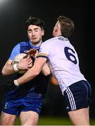 16 January 2024; Diarmuid Moriarty of UCD in action against Ryan Magill of Ulster University during the Electric Ireland Higher Education GAA Sigerson Cup Round 2 match between UCD and Ulster University at Dave Billings Park in Belfield, Dublin. Photo by Harry Murphy/Sportsfile