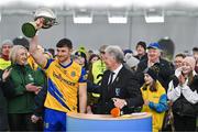 19 January 2024; Diarmuid Murtagh of Roscommon is presented with the cup by Connacht GAA president Vincent Neary after his side's victory in the Connacht FBD League final match between Roscommon and Galway at University of Galway Connacht GAA AirDome in Bekan, Mayo. Photo by Tyler Miller/Sportsfile