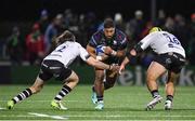 19 January 2024; Bundee Aki of Connacht is tackled by Benhard Janse van Rensburg, left, and Will Capon of Bristol Bears during the Investec Champions Cup Pool 1 Round 4 match between Connacht and Bristol Bears at the Dexcom Stadium in Galway. Photo by Seb Daly/Sportsfile