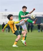 20 January 2024; Kian Quigley of Republic of Ireland in action against Caleb Butler of Australia during the international friendly match between Republic of Ireland MU15 and Australia U16 Schoolboys at the FAI National Training Centre in Abbotstown, Dublin. Photo by Seb Daly/Sportsfile