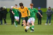 20 January 2024; Séan Spaight of Republic of Ireland in action against Will Dobson of Australia during the international friendly match between Republic of Ireland MU15 and Australia U16 Schoolboys at the FAI National Training Centre in Abbotstown, Dublin. Photo by Seb Daly/Sportsfile