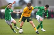 20 January 2024; Will Dobson of Australia in action against Republic of Ireland's Jason Spelman, left, and Brody Collins during the international friendly match between Republic of Ireland MU15 and Australia U16 Schoolboys at the FAI National Training Centre in Abbotstown, Dublin. Photo by Seb Daly/Sportsfile