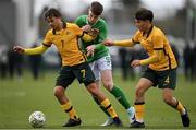 20 January 2024; Finn Duffy of Republic of Ireland in action against Australia players Oliver Sacks, left, and Lachlan McDonald during the international friendly match between Republic of Ireland MU15 and Australia U16 Schoolboys at the FAI National Training Centre in Abbotstown, Dublin. Photo by Seb Daly/Sportsfile