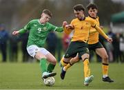 20 January 2024; Finn Duffy of Republic of Ireland in action against Munib Smajic of Australia during the international friendly match between Republic of Ireland MU15 and Australia U16 Schoolboys at the FAI National Training Centre in Abbotstown, Dublin. Photo by Seb Daly/Sportsfile