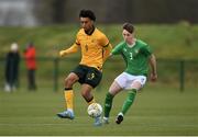 20 January 2024; Dallo Sandy of Australia in action against Ben Dumigan of Republic of Ireland during the international friendly match between Republic of Ireland MU15 and Australia U16 Schoolboys at the FAI National Training Centre in Abbotstown, Dublin. Photo by Seb Daly/Sportsfile