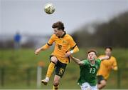 20 January 2024; Steve Nealon of Australia in action against Danny Burke of Republic of Ireland during the international friendly match between Republic of Ireland MU15 and Australia U16 Schoolboys at the FAI National Training Centre in Abbotstown, Dublin. Photo by Seb Daly/Sportsfile