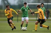 20 January 2024; Jason Spelman of Republic of Ireland in action against Australia players Oliver Sacks, left, and Alexander Nunes during the international friendly match between Republic of Ireland MU15 and Australia U16 Schoolboys at the FAI National Training Centre in Abbotstown, Dublin. Photo by Seb Daly/Sportsfile