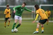 20 January 2024; Finn Duffy of Republic of Ireland in action against Petera Love of Australia during the international friendly match between Republic of Ireland MU15 and Australia U16 Schoolboys at the FAI National Training Centre in Abbotstown, Dublin. Photo by Seb Daly/Sportsfile