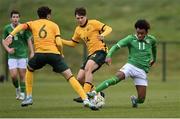 20 January 2024; David Dunne of Republic of Ireland in action against Australia players Will Dobson, centre, and Nicholas Badolato during the international friendly match between Republic of Ireland MU15 and Australia U16 Schoolboys at the FAI National Training Centre in Abbotstown, Dublin. Photo by Seb Daly/Sportsfile