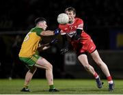 20 January 2024; Brendan Rogers of Derry in action against Jamie Brennan of Donegal during the Bank of Ireland Dr McKenna Cup final match between Derry and Donegal at O'Neills Healy Park in Omagh, Tyrone. Photo by Ramsey Cardy/Sportsfile