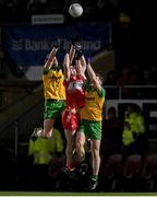 20 January 2024; Diarmuid Baker of Derry in action against Ciarán Thompson, left, and Jamie Brennan of Donegal during the Bank of Ireland Dr McKenna Cup final match between Derry and Donegal at O'Neills Healy Park in Omagh, Tyrone. Photo by Ramsey Cardy/Sportsfile