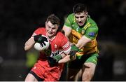 20 January 2024; Cormac Murphy of Derry in action against Caolan McGonagle of Donegal during the Bank of Ireland Dr McKenna Cup final match between Derry and Donegal at O'Neills Healy Park in Omagh, Tyrone. Photo by Ramsey Cardy/Sportsfile