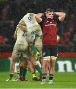 20 January 2024; A dejected Alex Kendellen of Munster as Northampton Saints players celebrate at the final whistle of during the Investec Champions Cup Pool 3 Round 4 match between Munster and Northampton Saints at Thomond Park in Limerick. Photo by Brendan Moran/Sportsfile