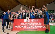 20 January 2024; UCC Demons players and coaches celebrate with the trophy after their side's victory in the Basketball Ireland Pat Duffy National Cup Final match between Irish Guide Dogs Ballincollig and UCC Demons at the National Basketball Arena in Tallaght, Dublin. Photo by Seb Daly/Sportsfile