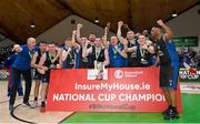 20 January 2024; UCC Demons players and coaches celebrate with the trophy after their side's victory in the Basketball Ireland Pat Duffy National Cup Final match between Irish Guide Dogs Ballincollig and UCC Demons at the National Basketball Arena in Tallaght, Dublin. Photo by Seb Daly/Sportsfile