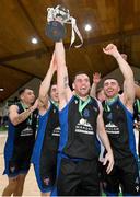 20 January 2024; UCC Demons captain Kyle Hosford celebrates with the trophy alongside his teammates after their side's victory in the Basketball Ireland Pat Duffy National Cup Final match between Irish Guide Dogs Ballincollig and UCC Demons at the National Basketball Arena in Tallaght, Dublin. Photo by Seb Daly/Sportsfile
