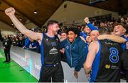 20 January 2024; David Lehane of UCC Demons, left, celebrates with supporters after the Basketball Ireland Pat Duffy National Cup Final match between Irish Guide Dogs Ballincollig and UCC Demons at the National Basketball Arena in Tallaght, Dublin. Photo by Seb Daly/Sportsfile