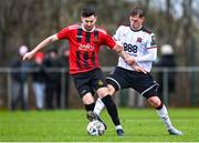 21 January 2024; Stephen Cleary of Malahide United AFC in action against Hayden Muller of Dundalk during the PTSB Leinster Senior Cup Group A match between Malahide United and Dundalk at Gannon Park in Malahide, Dublin. Photo by Tyler Miller/Sportsfile