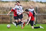 21 January 2024; Archie Davies of Dundalk on his way to scoring his side's third goal despite the efforts of Thomas Lynch of Malahide United AFC during the PTSB Leinster Senior Cup Group A match between Malahide United and Dundalk at Gannon Park in Malahide, Dublin. Photo by Tyler Miller/Sportsfile